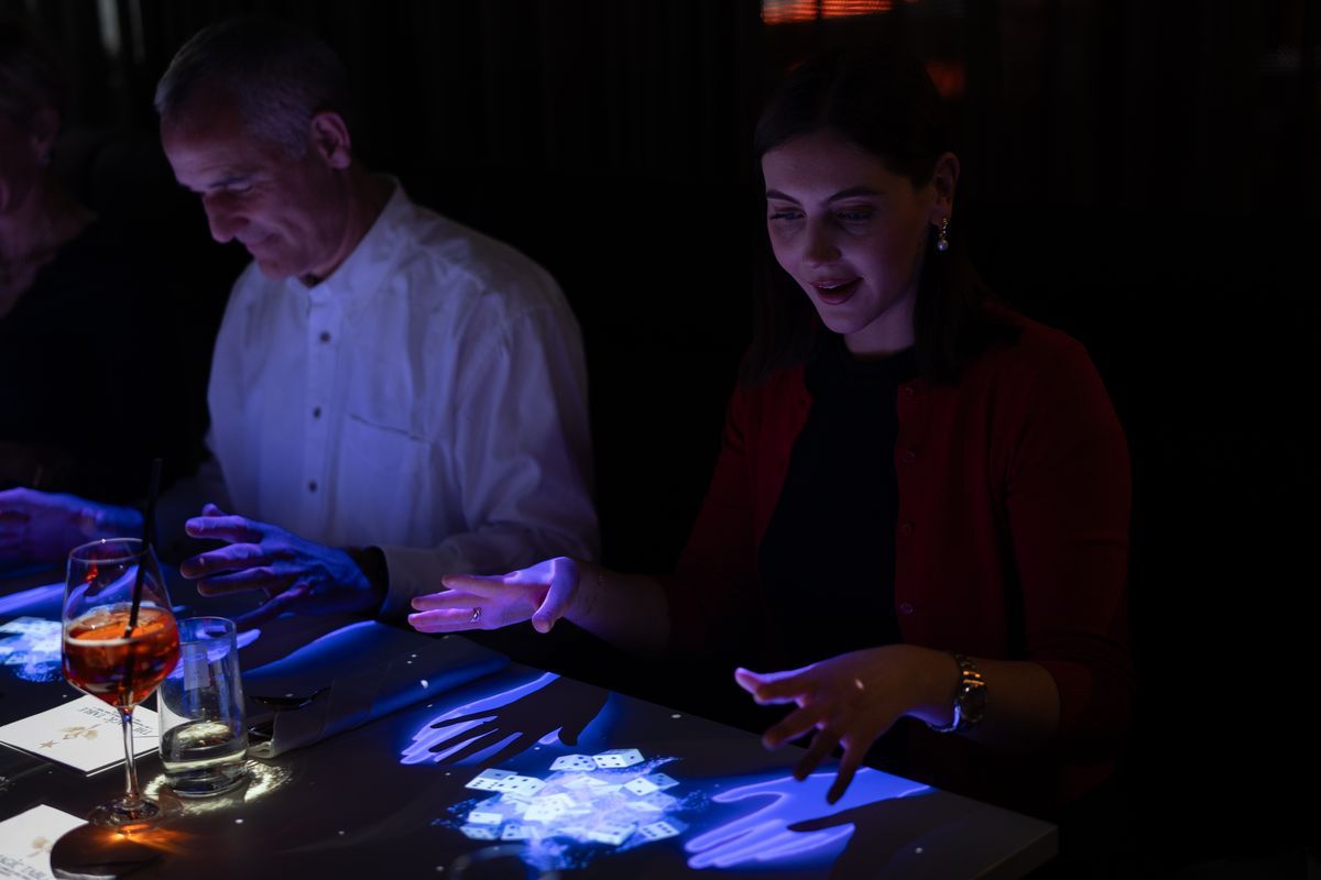 The Magic Table Berlin — guests performing interactive card magic with the Clairvoyants